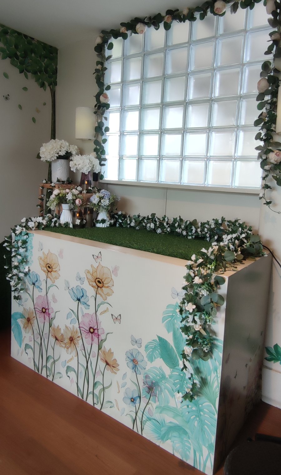 The altar in our send-off hall, with flowers, ivy and a glass-block window